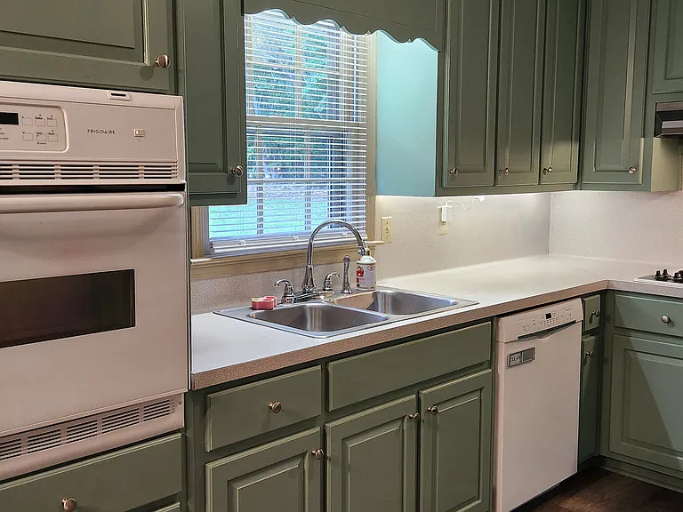 Updated kitchen overlooking the large backyard. Freshly painted cabinets with brand new doors.