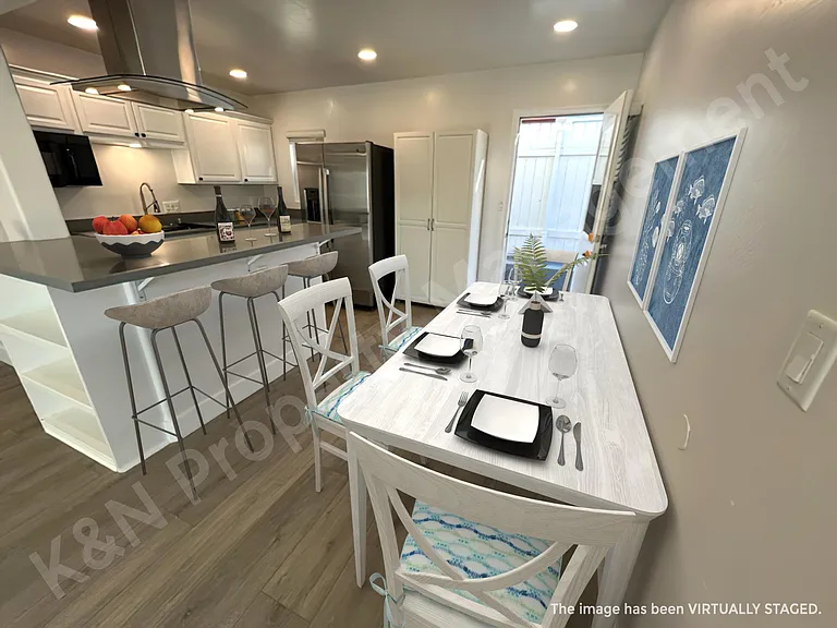Kitchen bar and dining area with French door opening to the outside as additional access.