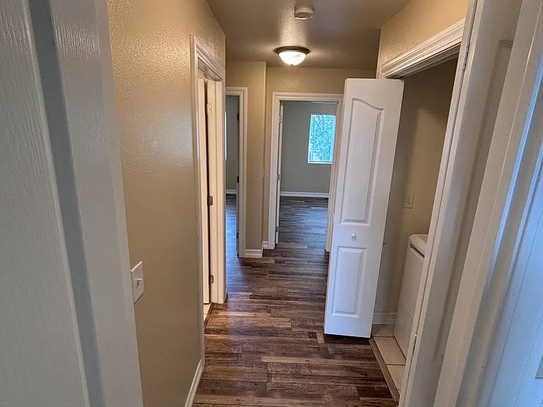 Exiting master towards laundry, guest bath, and 2 spare bedrooms.