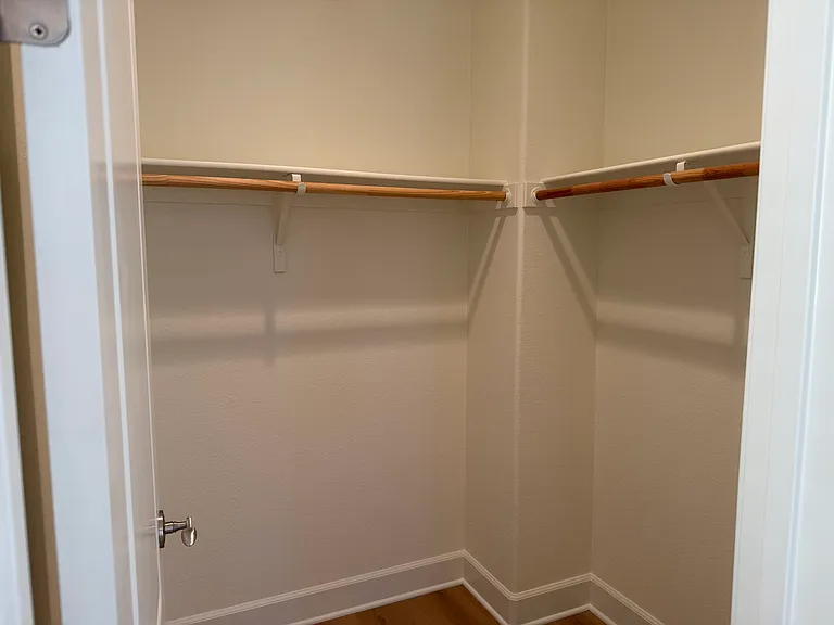 Spacious Bedroom #1 features multiple windows, vinyl flooring, walk-in closet, a separate bathroom sink and share a Jack-and-Jill style bathroom for the bathtub and toilet.