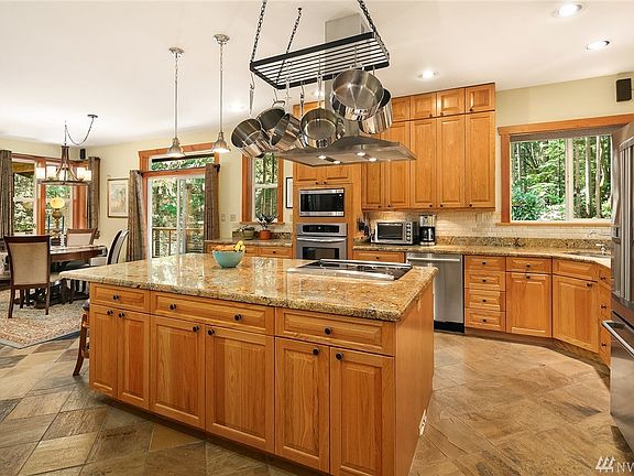 Light and bright and ready for anything, this kitchen is well laid out and beautifully appointed with stone tile floors, granite counter tops and newer, quality appliances. Eat at the bar or in the nearby dining area with easy access to the deck.