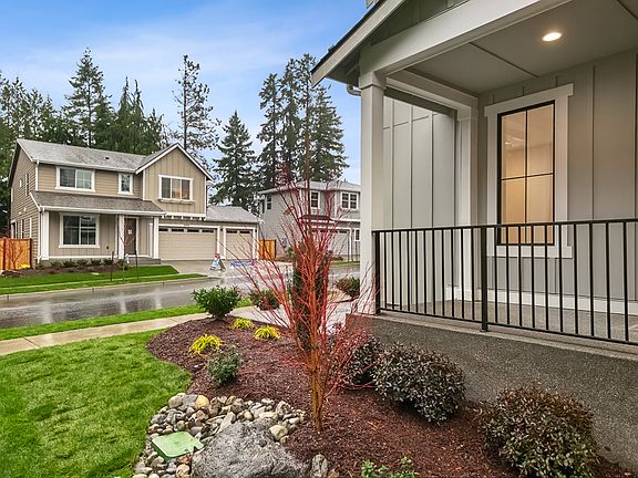 Fully landscaped front yard and welcoming patio