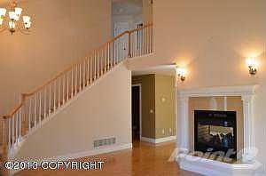 Living room w/ grand staircase
