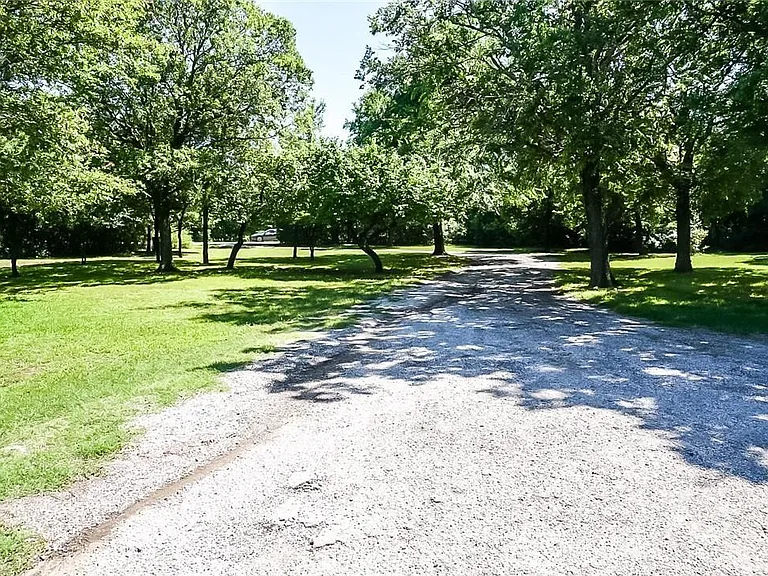 Gravel driveway leading up to property