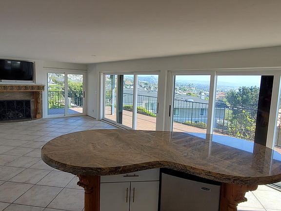 Second refrigerator under island.
Television over fireplace.