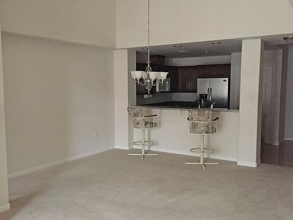 Large dining area with counter space with two stools include