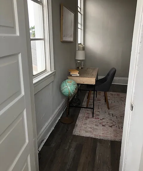 View coming upstairs with room being used as an office in the past