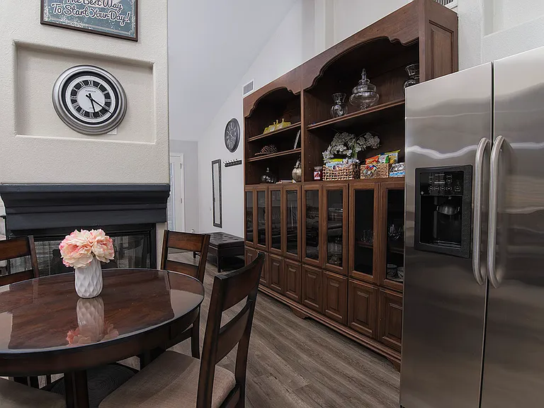 Kitchen is equipped with a stainless steel double door refrigerator that has an exterior dispenser for filtered water and ice. Full wall storage cabinet acts an extra pantry.