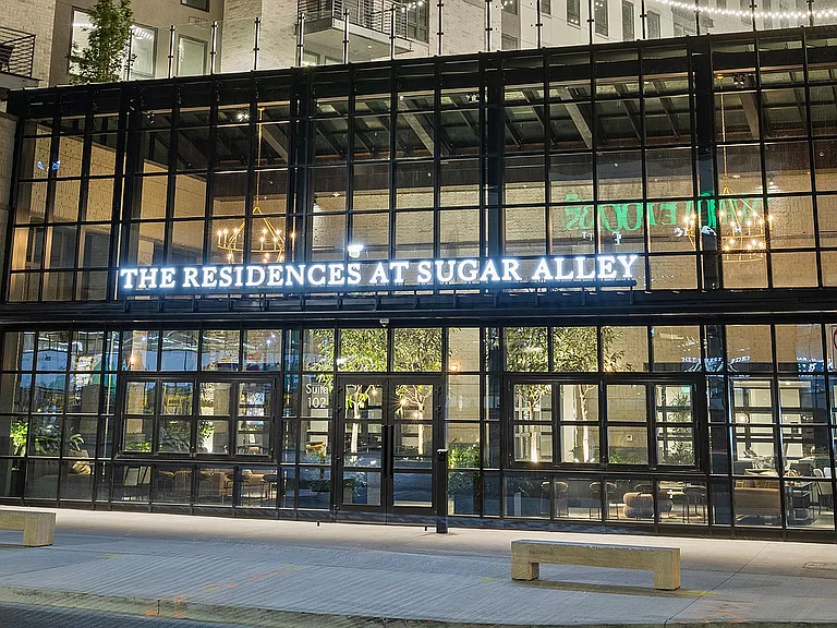 Front entrance of Sugar Alley lit with evening ambiance
