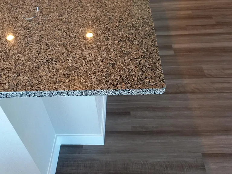 Close-up of Island corner showing indent for knees. Note the Shaw LVP floring.