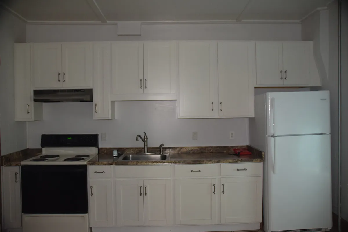 Large eat-in kitchen with new fridge, tile floor, electric range, newer cabinets, back door to back porch w/ stairs to ground level. - 33 Main St #1
