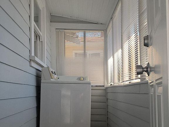 Private in unit laundry room on enclosed porch