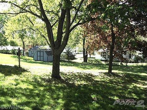 Large Back Yard with lots of Trees.