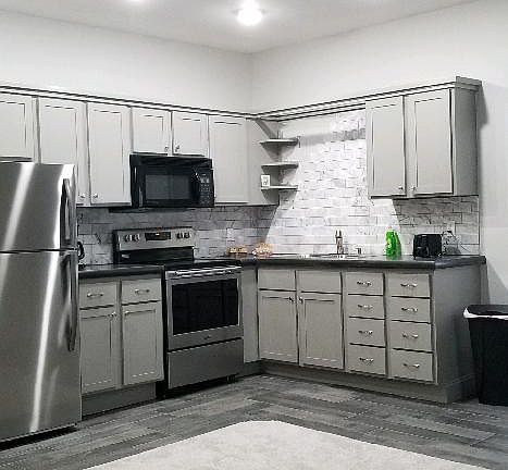 Kitchen with new appliances, tile backsplash, concrete countertops