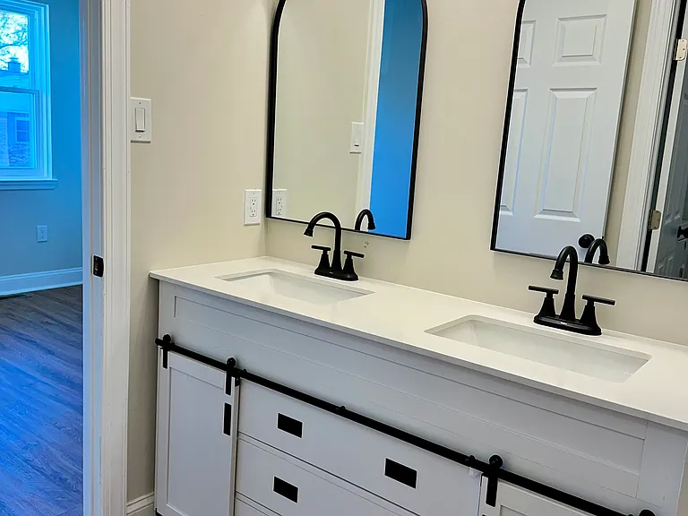Stunning modern farmhouse bathroom with double sinks, individual mirrors, and abundant storage_featuring six drawers and dedicated his-and-hers cabinets for ultimate convenience and style.