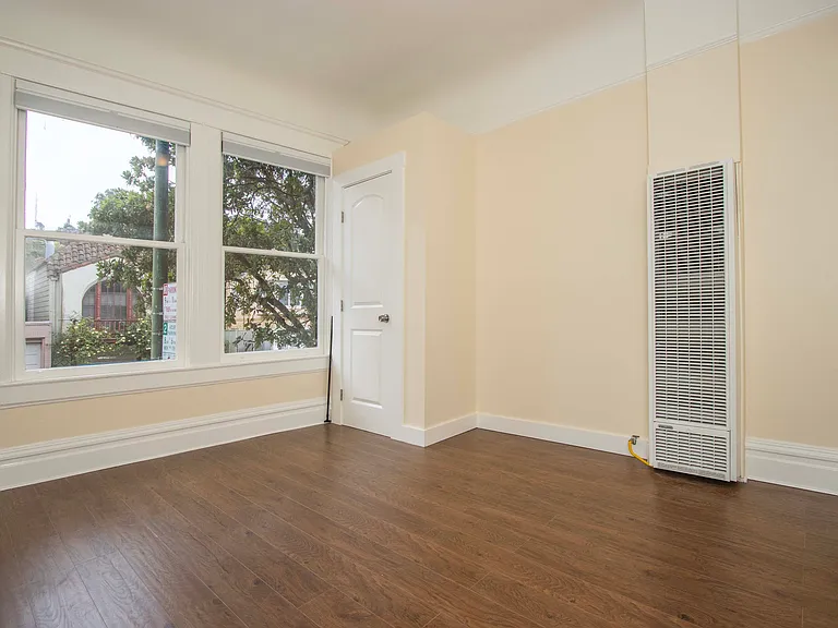 Front bedroom as viewed from its bedroom door; blackout honeycomb shades that can be opened/closed from both top and bottom