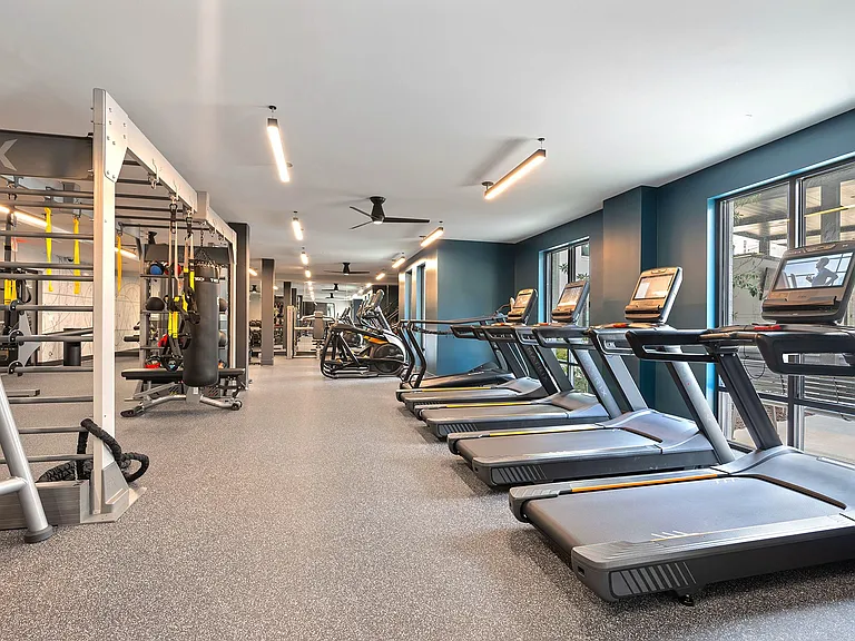 Fully-equipped fitness center with cardio and weight machines and a separate fitness studio with Peloton bikes and virtual trainer