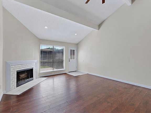 huge living area with vaulted ceilings and fireplace