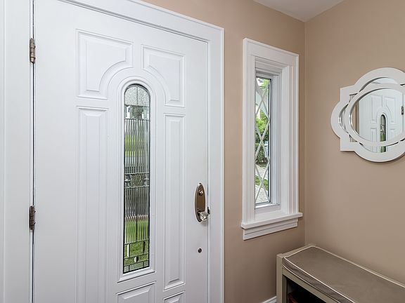 Welcoming entrance foyer and attractive front door with glass panel.