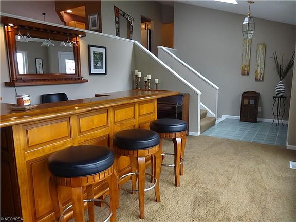 Welcoming front room has custom built bar that can stay or go... your choice.  Flexible space could be an office, formal living room, formal dining room!