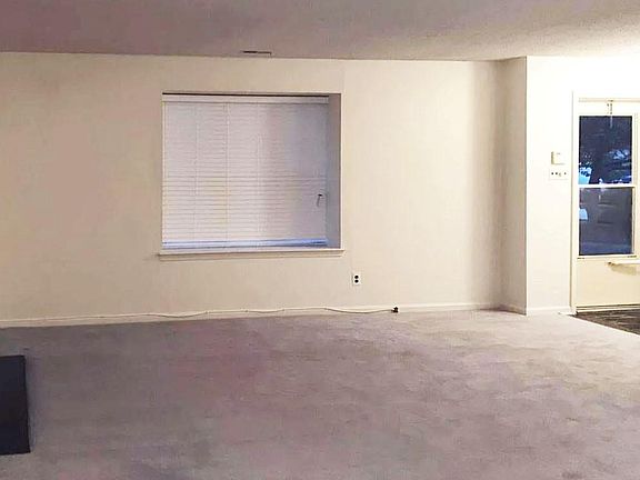 living room with wood burning fireplace