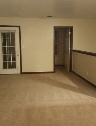 living room facing deck and bonus room