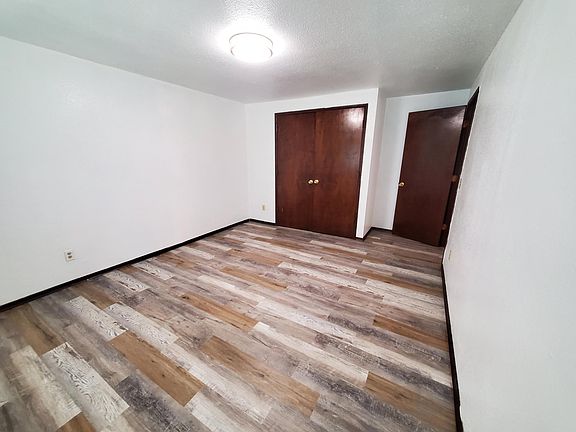 View of a main floor bedroom with large closet adjacent to bathroom.