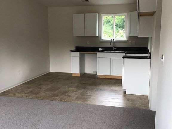 View from front door: Living room to kitchen with granite countertops