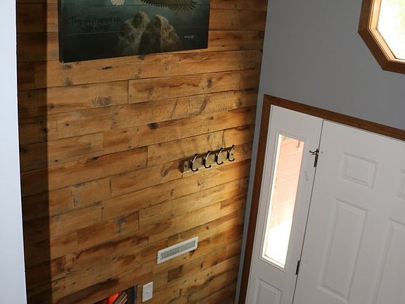 Front Entry has volume ceiling and beautiful barn wood accent wall.