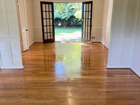 Dining room with French doors to backyard and living room in foreground