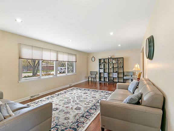 The 23x13 living room has handsome hardwood floors and recessed lights