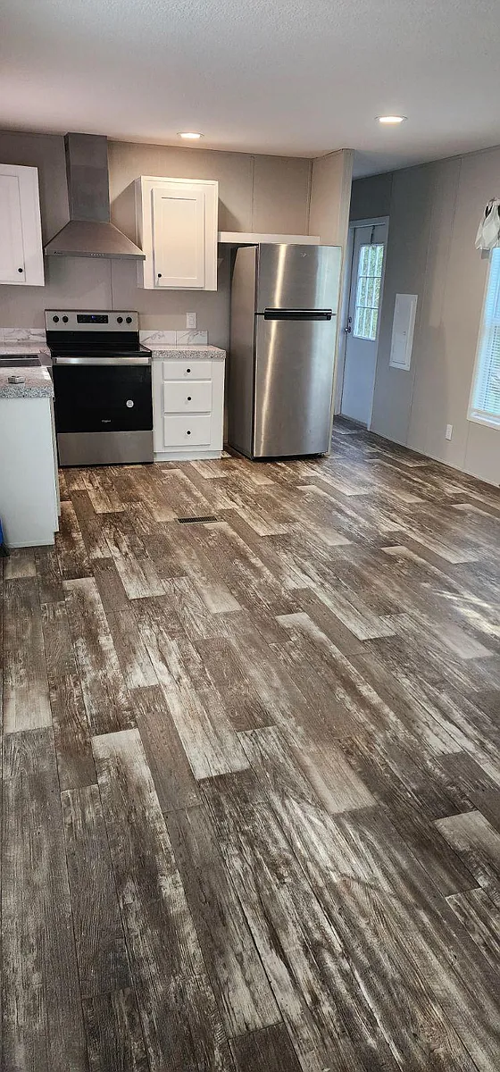 Kitchen, dinning, and partial living room view. - 7241 SW 10th St