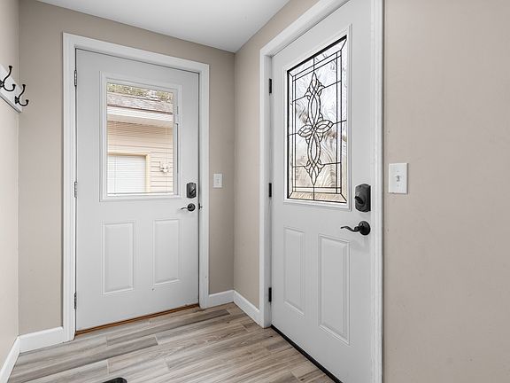 This dual entry has one door that leads to the detached garage and another to the street.