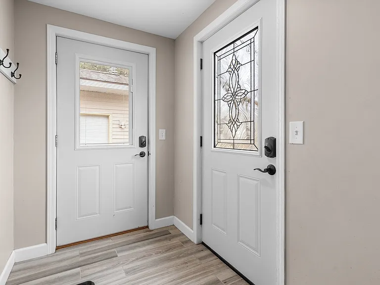 This dual entry has one door that leads to the detached garage and another to the street.