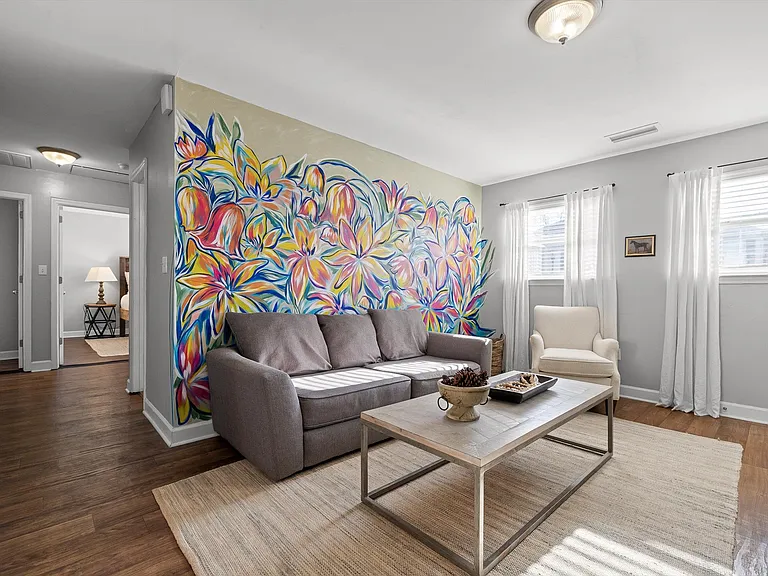 This mural was painted by a local artist, known for her murals around town. The couch converts to a bed.
