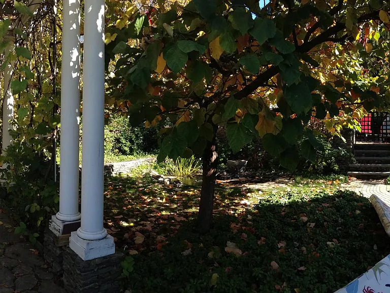 stone walkway under pergola to studio door