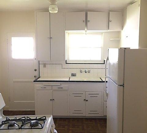Charming kitchen - freshly painted! And yes, that is a rear door that would take you out to the charming common yard and laundry facility.