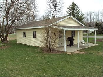 22x30 detached garage with a work shop and covered front porch.