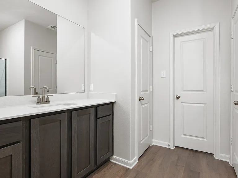 The master bathroom has a sprawling vanity space.