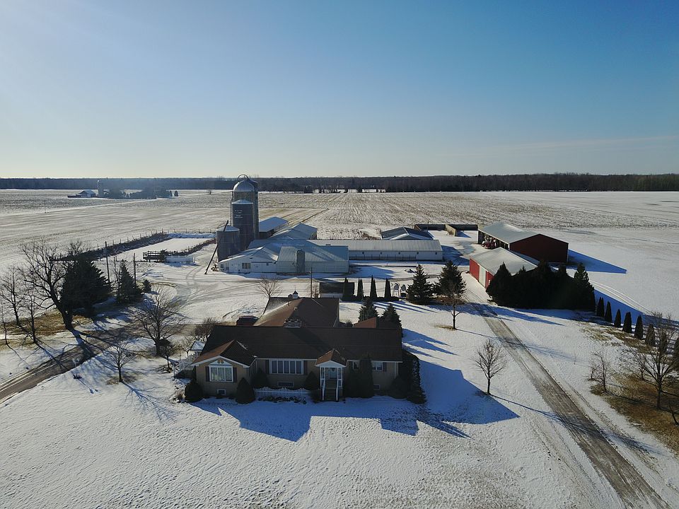 View of home with sheds/barn