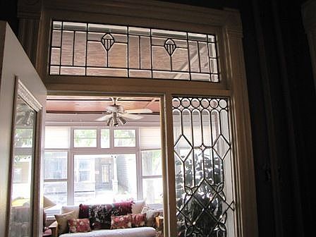 ornate detailed beveled glass and pocket doors thru out
