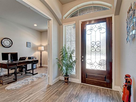 Wood look tile flooring throughout the main living areas of the home. Private office located at the front of the home with French Doors.