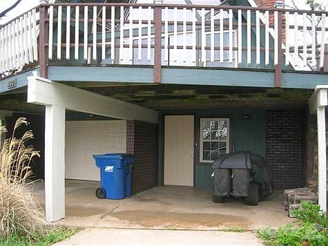 two car carports and entrance to the house and garage