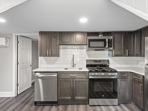 Kitchen with dishwasher, new cabinets, new appliances and quartz countertops.