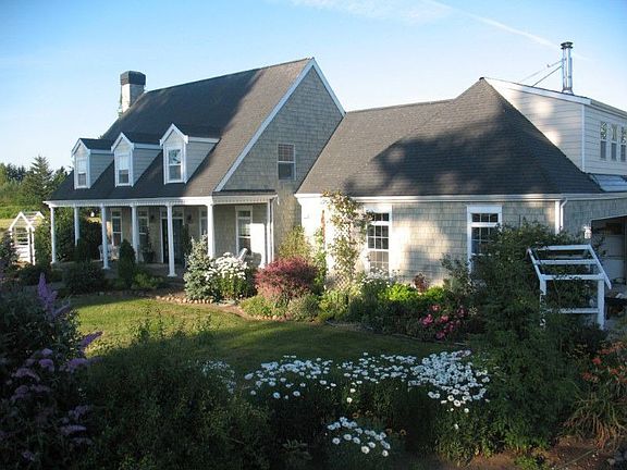 Mature landscaping allows you to enjoy your front porch to its fullest