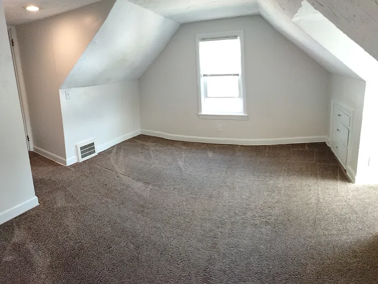 2nd floor bedroom #3 with closet and door to 1/2 bath.