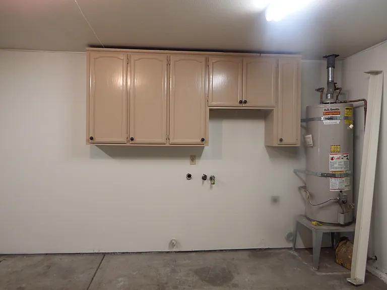 2 car garage, laundry hookups with cabinets overhead. Side man door leads into backyard.