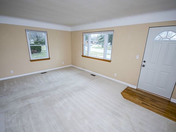 Enter from the front door into the bright living room (18x12).  Carpets throughout the home have been shampooed and this room has a fresh coat of paint.  Both front and back doors have been wired for a security system.