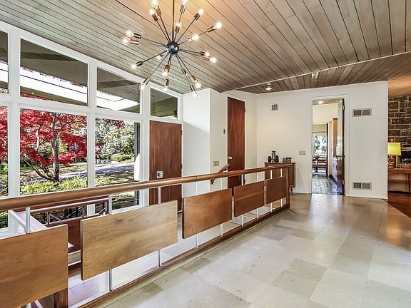 Sun-lit foyer with mid-century railing
