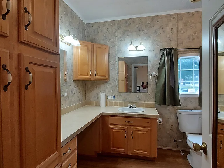Back Master Bathroom has stacked cupboards and an extra long vanity countertop.